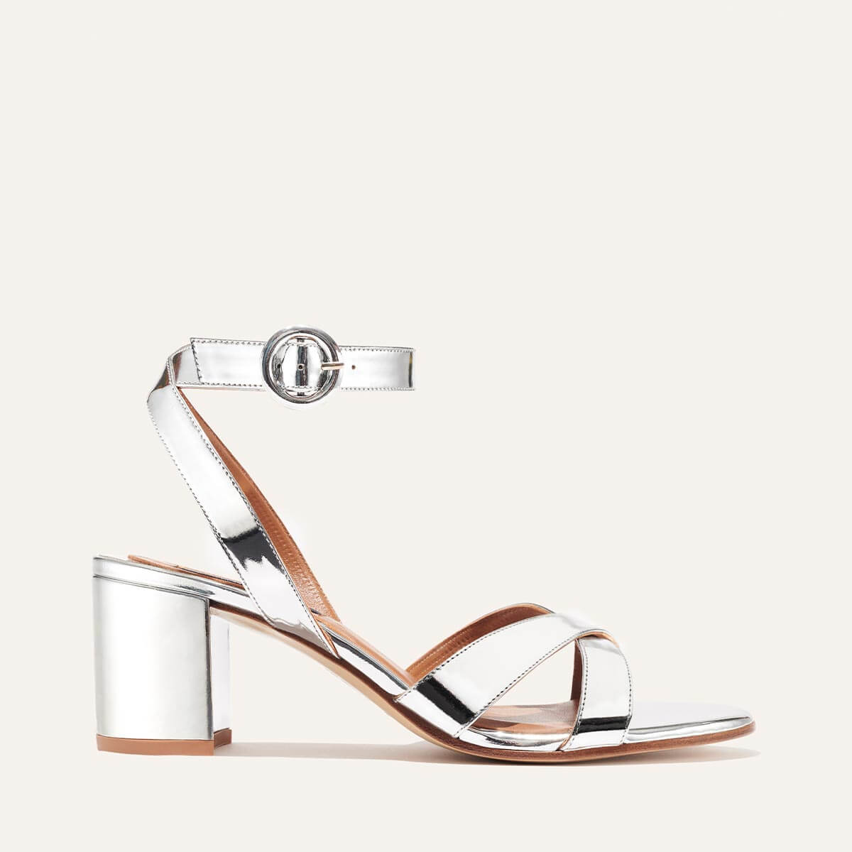 Margaux's classic City Sandal in metallic silver patent leather with comfortable straps and a walkable block heel
