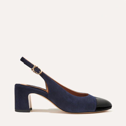 The Cluny Slingback in Navy Suede, featuring a sleek patent captoe detail with an adjustable buckle and a comfortable 2.5-inch black heel. 