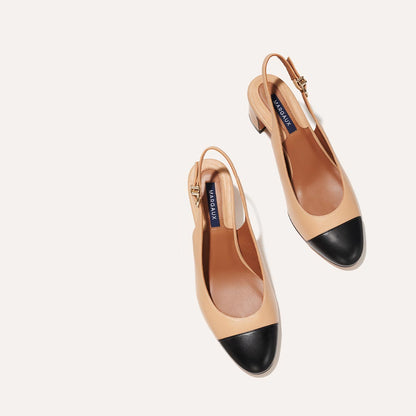The Cluny Slingback in Dune Nappa, featuring a sleek captoe detail with an adjustable buckle and a comfortable 2.5-inch black heel.