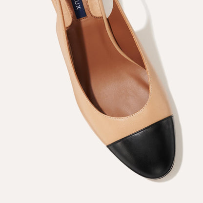 The Cluny Slingback in Dune Nappa, featuring a sleek captoe detail with an adjustable buckle and a comfortable 2.5-inch black heel.