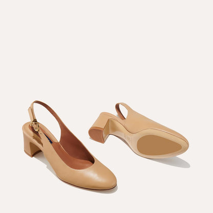 The Cluny Slingback in Dune Nappa, featuring a sleek Italian nappa leather upper with an adjustable buckle and a comfortable 2.5-inch black heel.