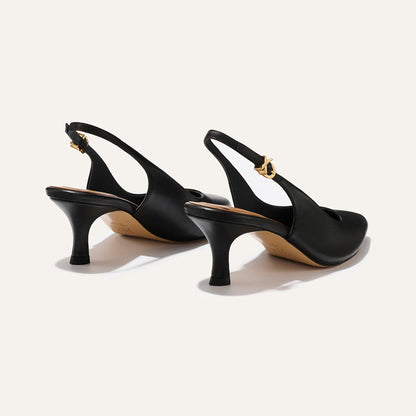 The Colette - Black Nappa by margaux-development: black leather slingback heels with snip nose toes, medium curved heels, and gold buckle straps, shown on a light neutral background.