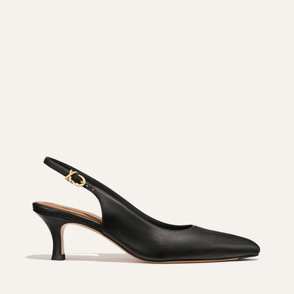 The Colette - Black Nappa by margaux-development features a black snip toe, slingback style, low micro heel, and gold buckle on the ankle strap, displayed against a plain light background.
