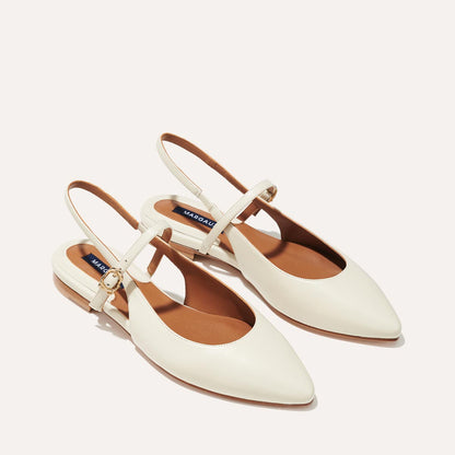 The Cluny Slingback in Ecru Nappa, a ballet flat with a pointed toe, a slingback strap and an adjustable strap across the top of the foot for a secure fit.