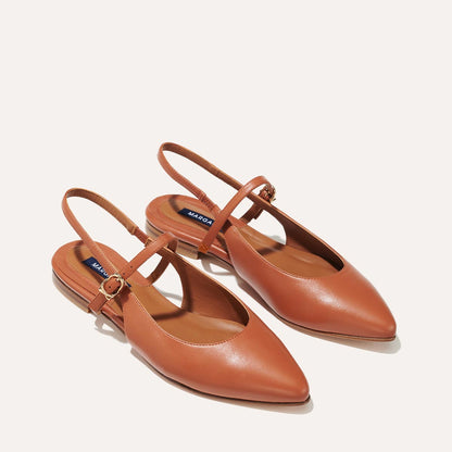 The Crosby Slingback in Saddle Nappa, a ballet flat with a pointed toe, a slingback strap and an adjustable strap across the top of the foot for a secure fit.