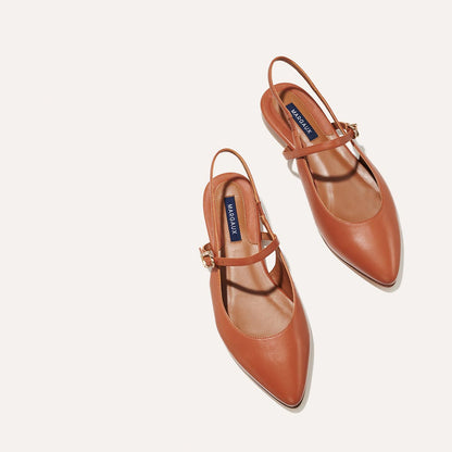 The Cluny Slingback in Saddle Nappa, a ballet flat with a pointed toe, a slingback strap and an adjustable strap across the top of the foot for a secure fit.