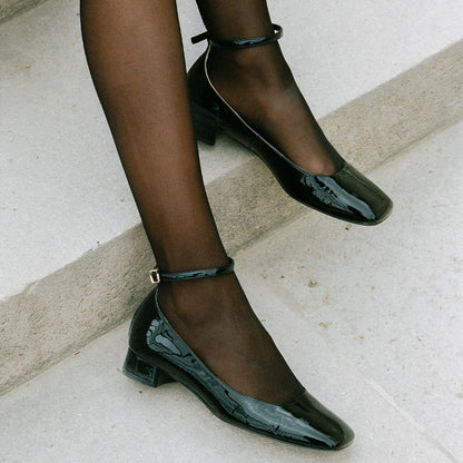 The Daphne in Black Patent, featuring a chic square toe, a supportive ankle strap and a versatile 1-inch block heel,