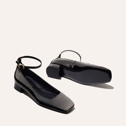 The Daphne in Black Patent, featuring a chic square toe, a supportive ankle strap and a versatile 1-inch block heel,