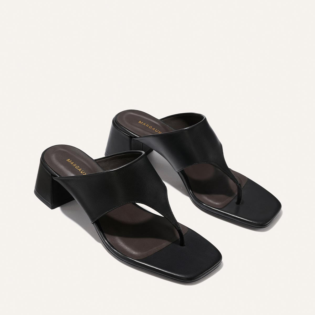 Pair of black sandals on a light gray background