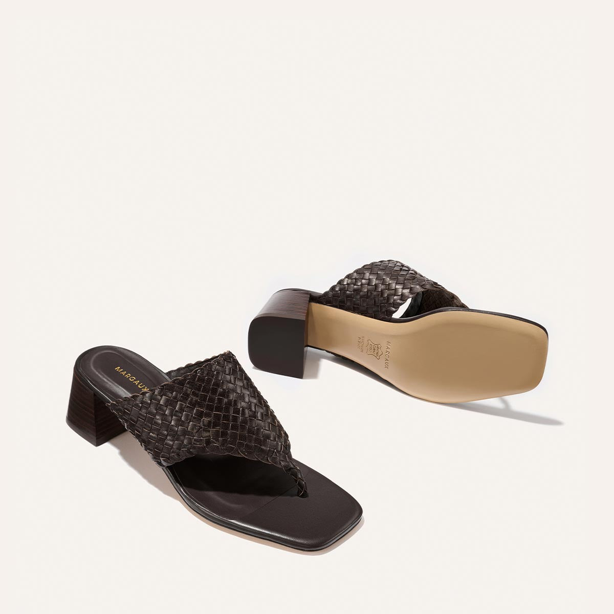 Pair of brown textured sandals on a white background