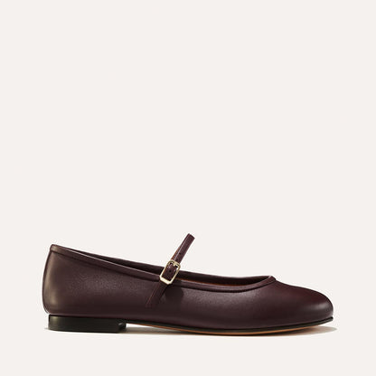 The Demi Jane in Burgundy Nappa, a ballet flat with a rounded toe and an adjustable strap for a secure fit.