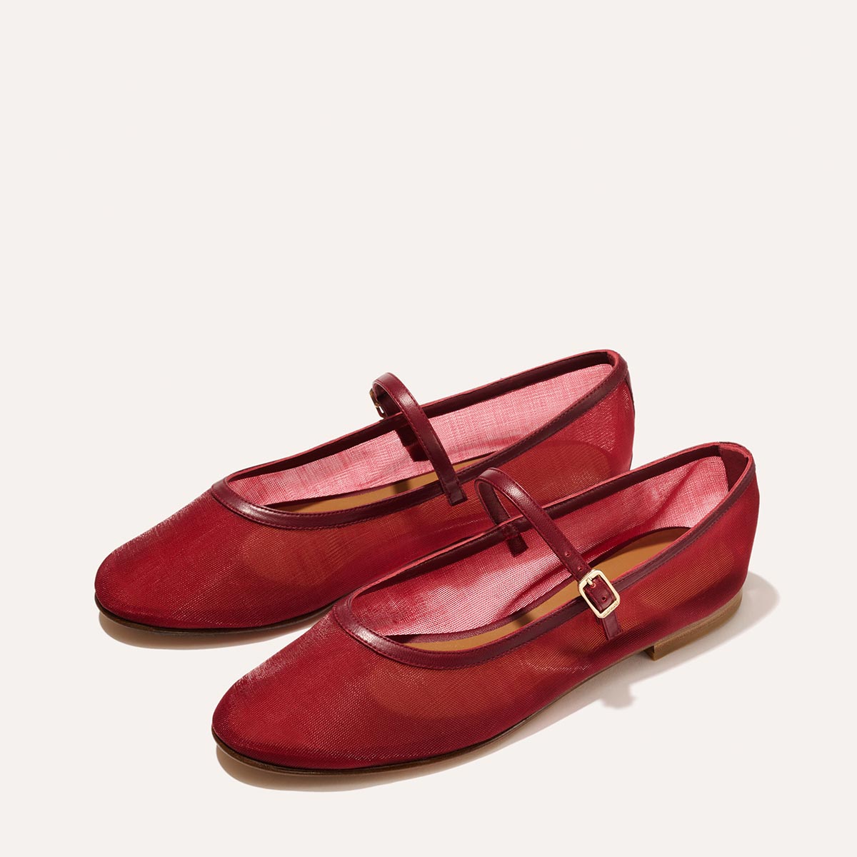 The Demi Jane in Crimson Mesh, a sheer ballet flat with a rounded toe and an adjustable strap for a secure fit.