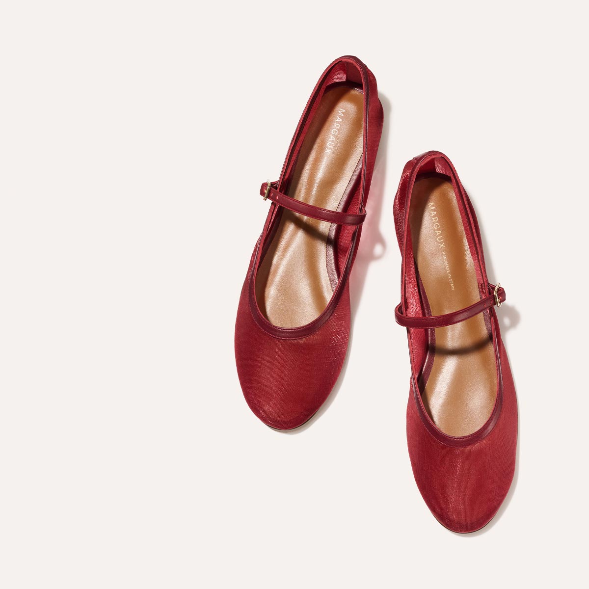 The Demi Jane in Crimson Mesh, a sheer ballet flat with a rounded toe and an adjustable strap for a secure fit.