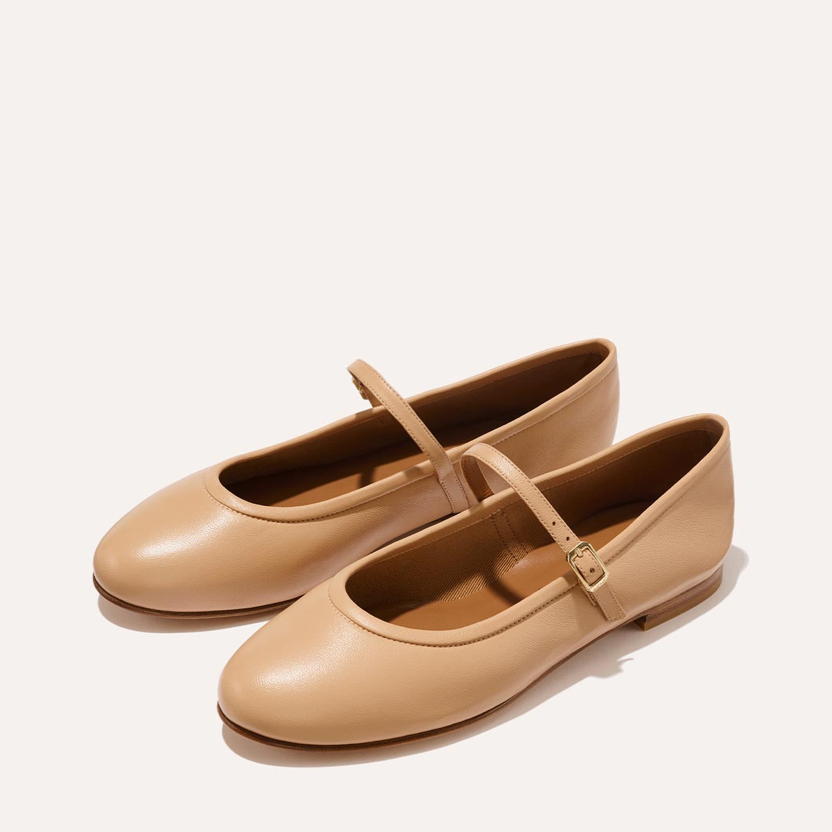 The Demi Jane in buttery soft Dune Nappa, a ballet flat with a rounded toe and an adjustable strap for a secure fit.