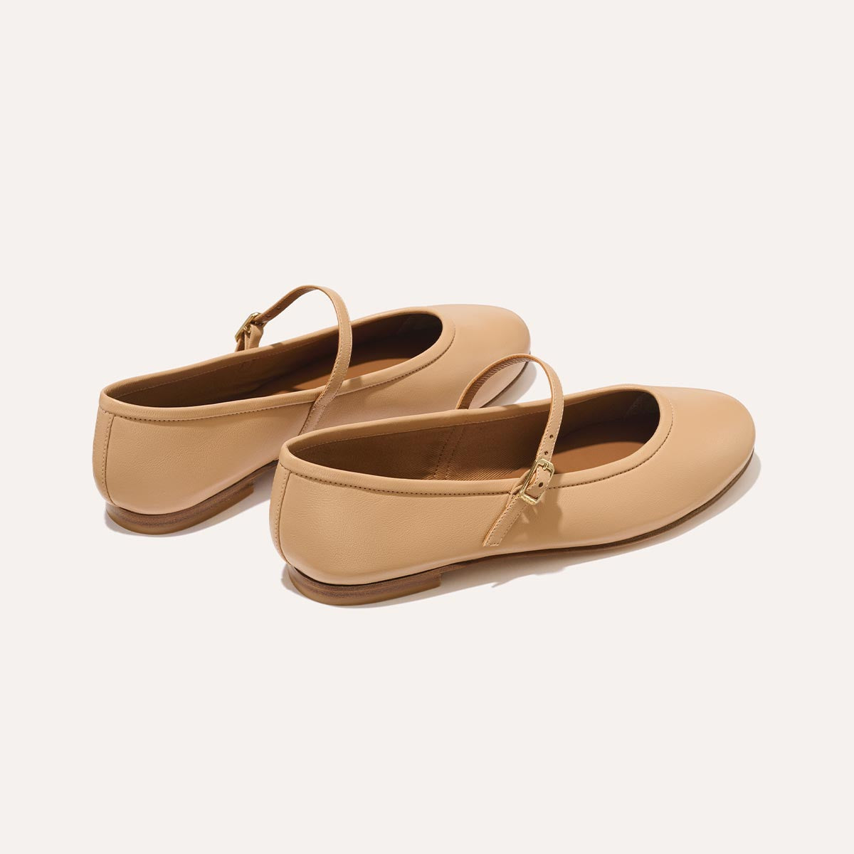 The Demi Jane in buttery soft Dune Nappa, a ballet flat with a rounded toe and an adjustable strap for a secure fit.