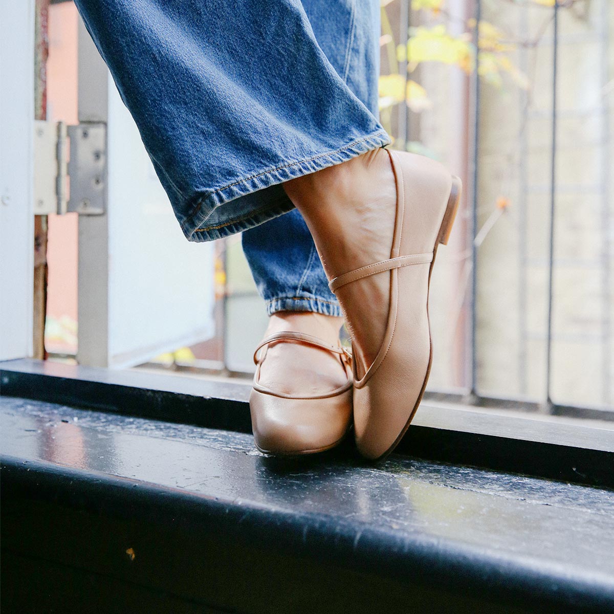 The Demi Jane in buttery soft Dune Nappa, a ballet flat with a rounded toe and an adjustable strap for a secure fit.