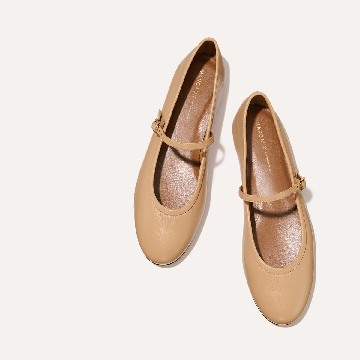 The Demi Jane in buttery soft Dune Nappa, a ballet flat with a rounded toe and an adjustable strap for a secure fit.