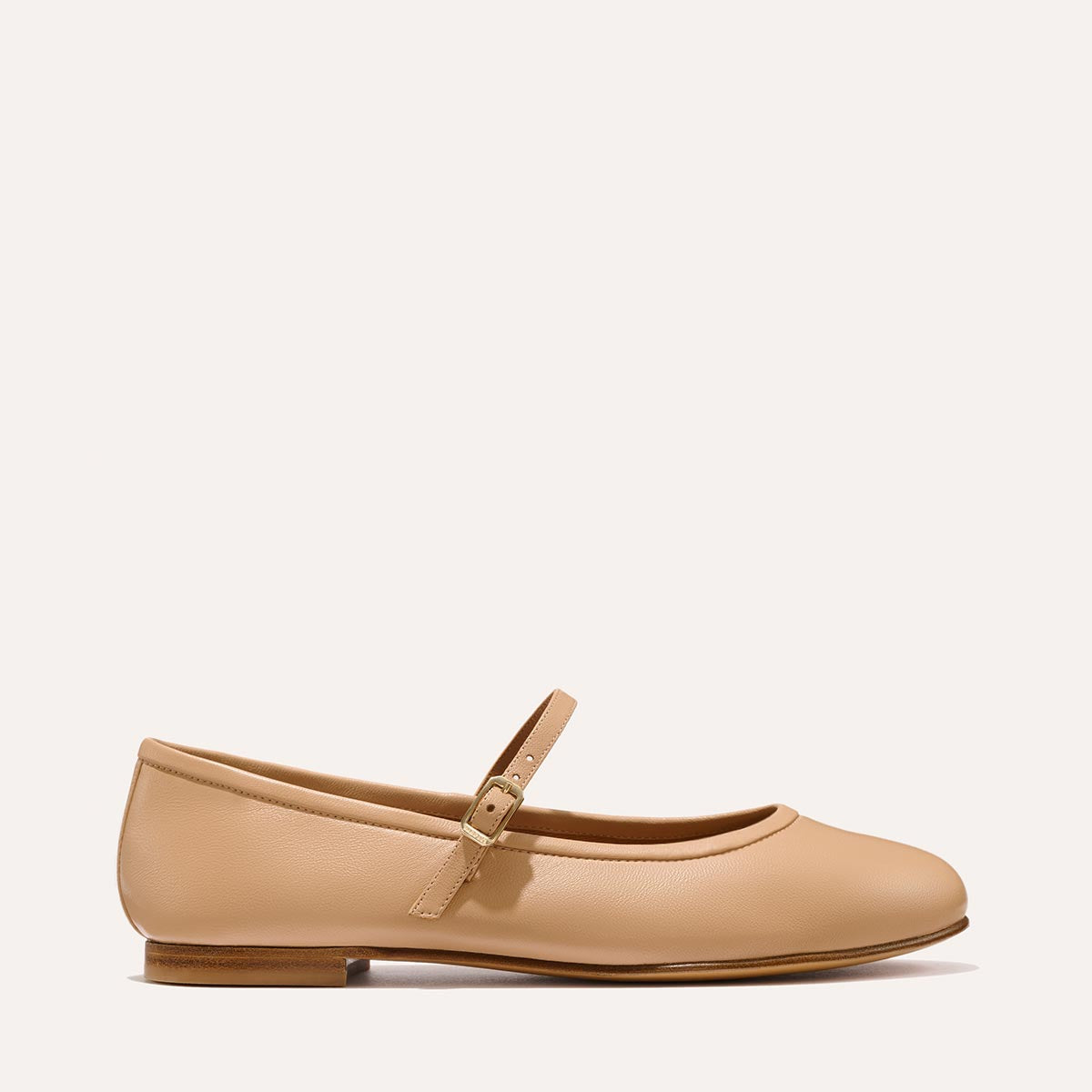 The Demi Jane in buttery soft Dune Nappa, a ballet flat with a rounded toe and an adjustable strap for a secure fit.