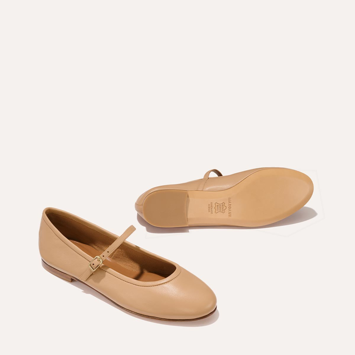 The Demi Jane in buttery soft Dune Nappa, a ballet flat with a rounded toe and an adjustable strap for a secure fit.