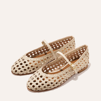 A ecru woven Mary Jane flat made from handwoven leather with a classic strap.