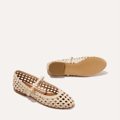 A ecru woven Mary Jane flat made from handwoven leather with a classic strap.