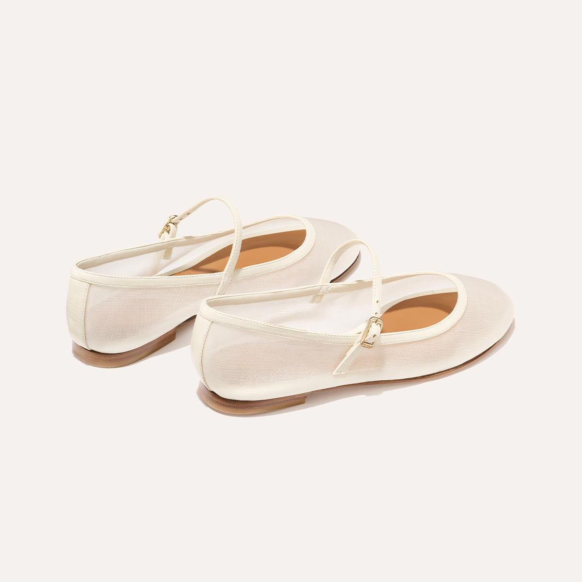 The Demi Jane in Ivory Mesh, a sheer ballet flat with a rounded toe and an adjustable strap for a secure fit.