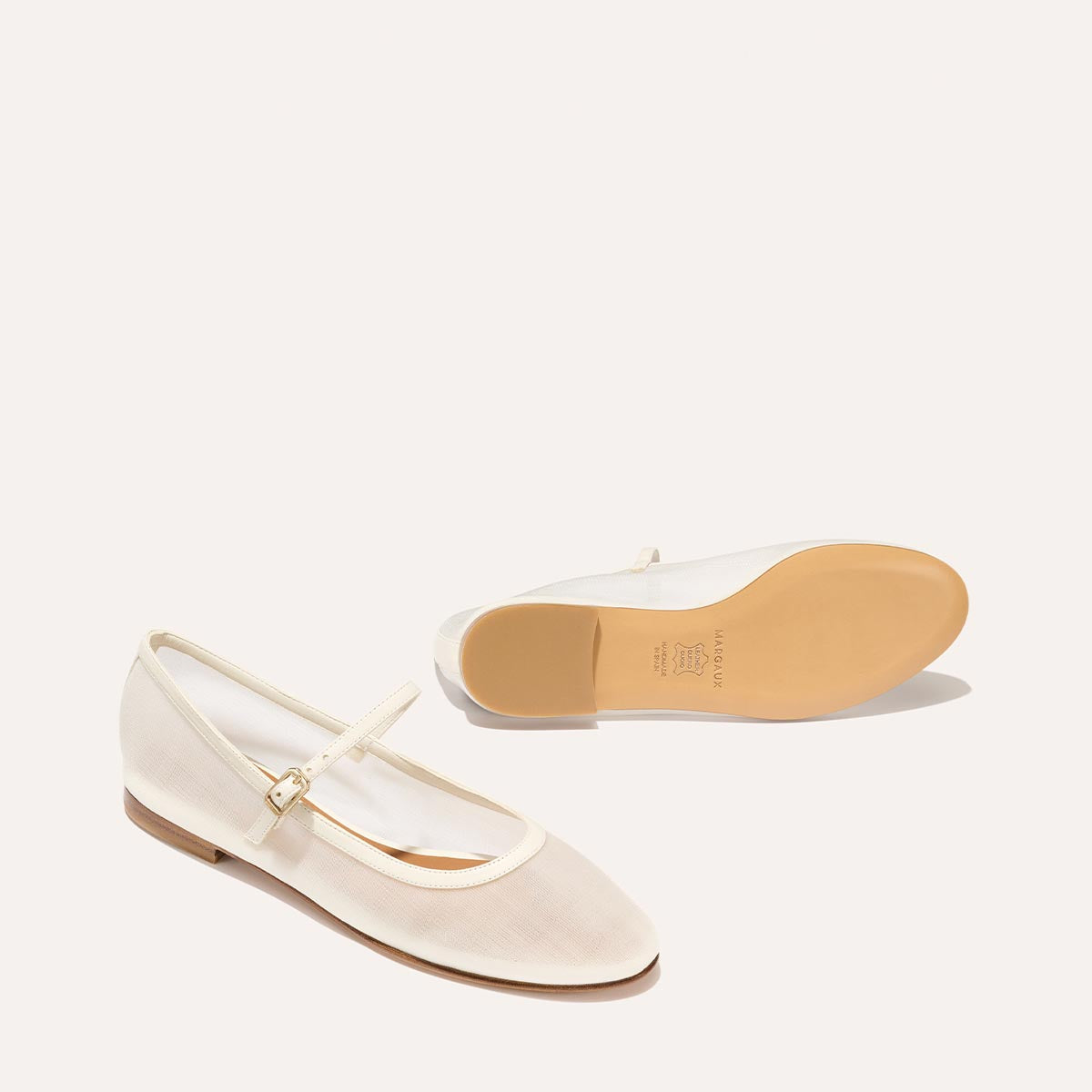 The Demi Jane in Ivory Mesh, a sheer ballet flat with a rounded toe and an adjustable strap for a secure fit.