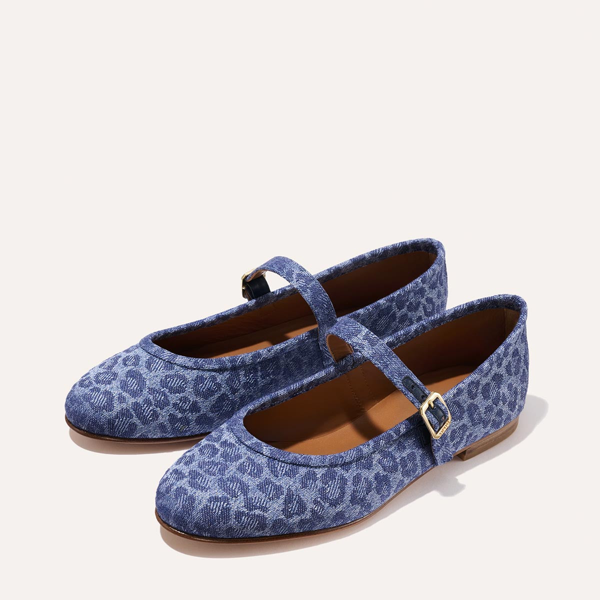 The Demi Jane in blue Leopard Denim, a ballet flat with a rounded toe and an adjustable strap for a secure fit.