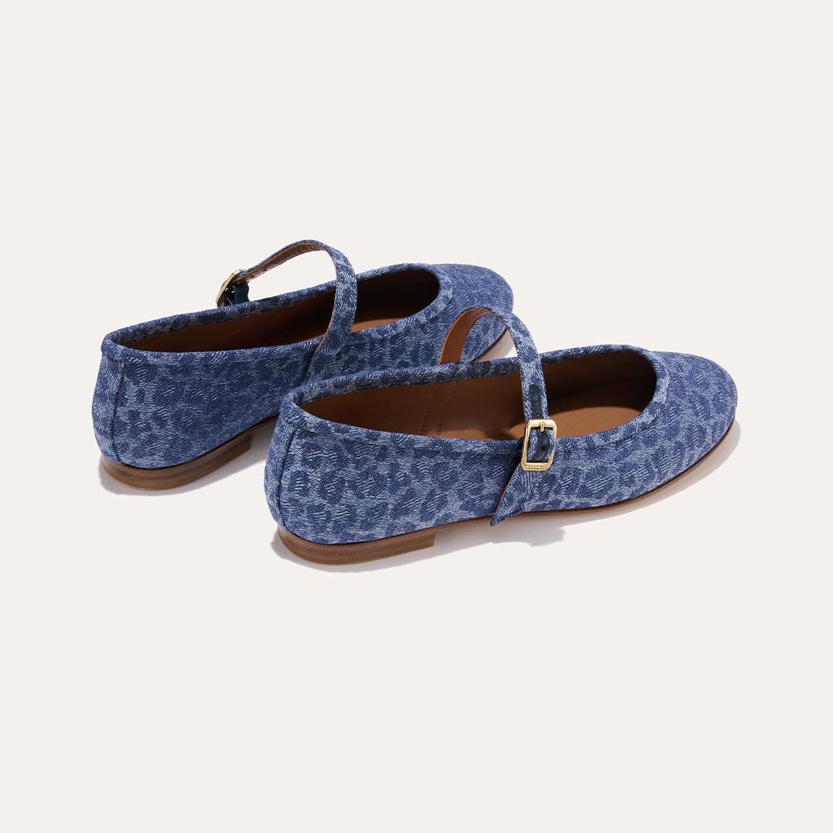 The Demi Jane in blue Leopard Denim, a ballet flat with a rounded toe and an adjustable strap for a secure fit.