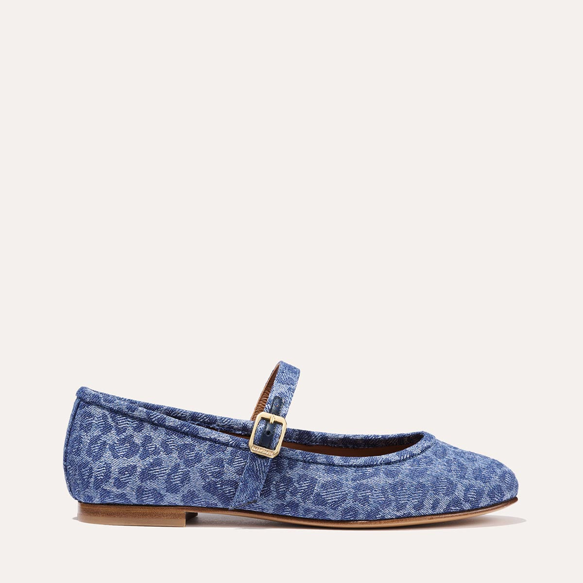 The Demi Jane in blue Leopard Denim, a ballet flat with a rounded toe and an adjustable strap for a secure fit.