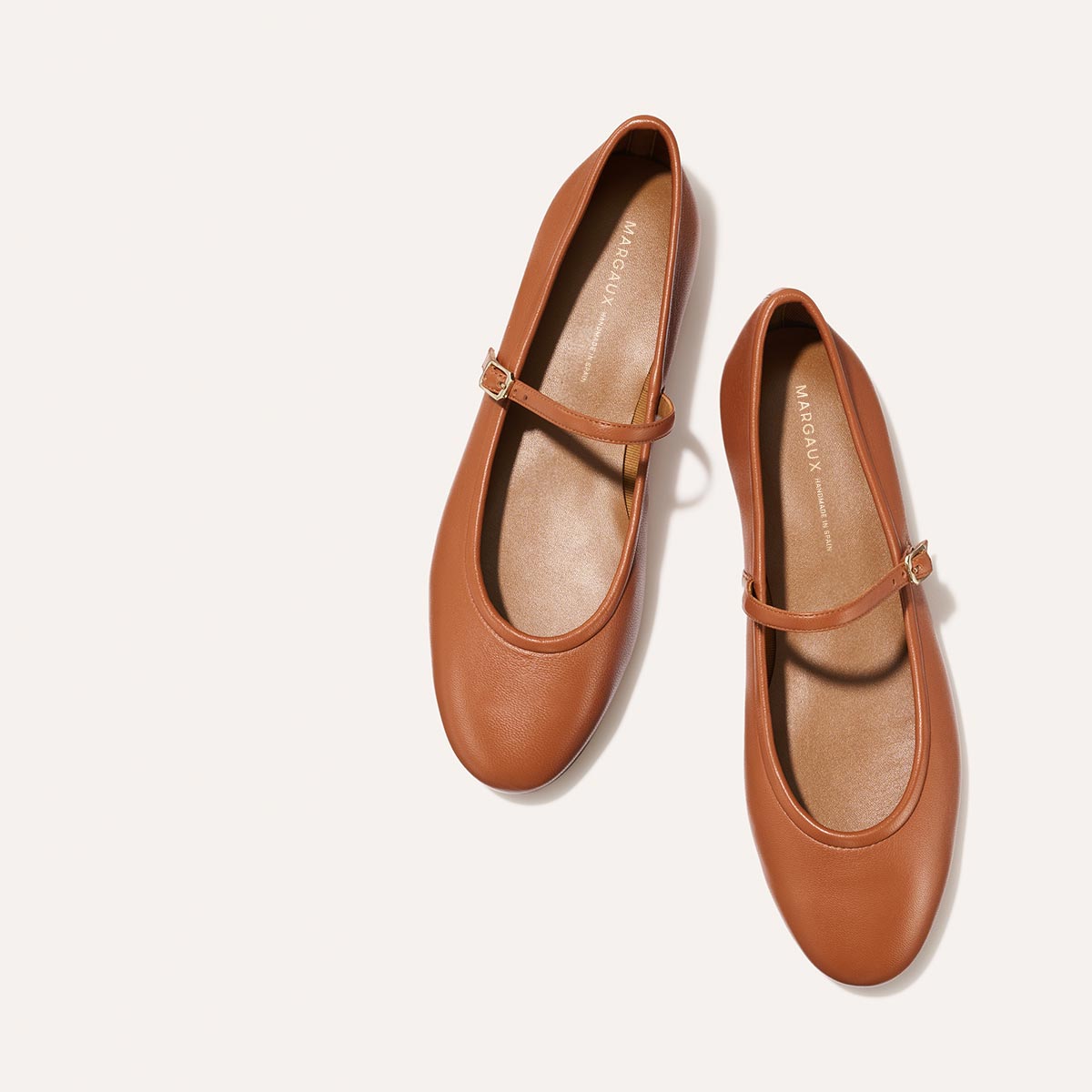 The Demi Jane in buttery soft Saddle Nappa, a ballet flat with a rounded toe and an adjustable strap for a secure fit.