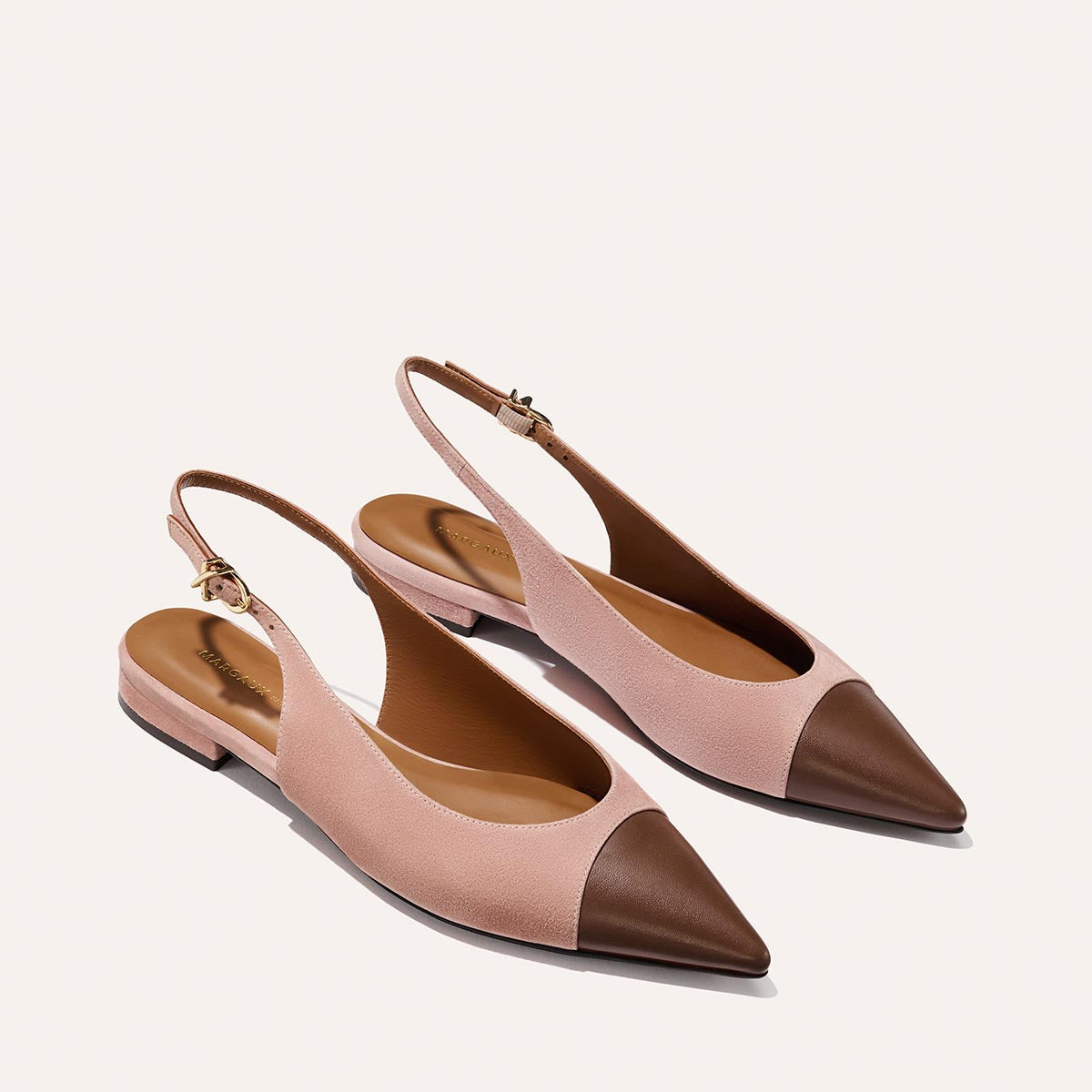 The Elise by margaux-development: stylish pointed-toe slingback flats in dusty rose suede with chocolate nappa leather cap toes and a durable leather sole, displayed on a white background.