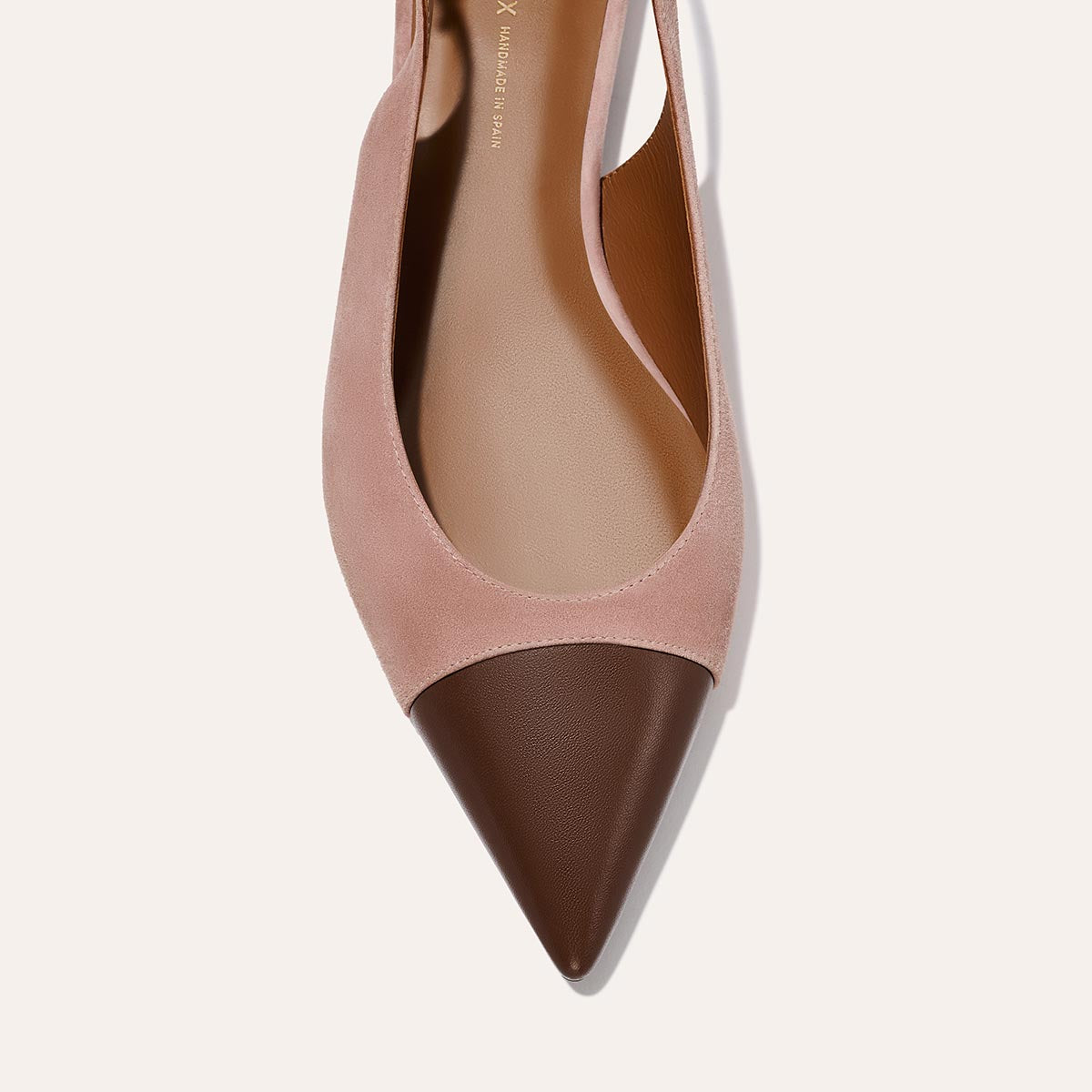 A close-up top view of The Elise by margaux-development, featuring dusty rose suede and chocolate nappa leather with a pointed toe and slingback flat design, displayed against a light background.