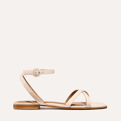 The Flat Sandal in magnolia nappa, a minimal sandal featuring thin, flattering straps with a subtly square toe.