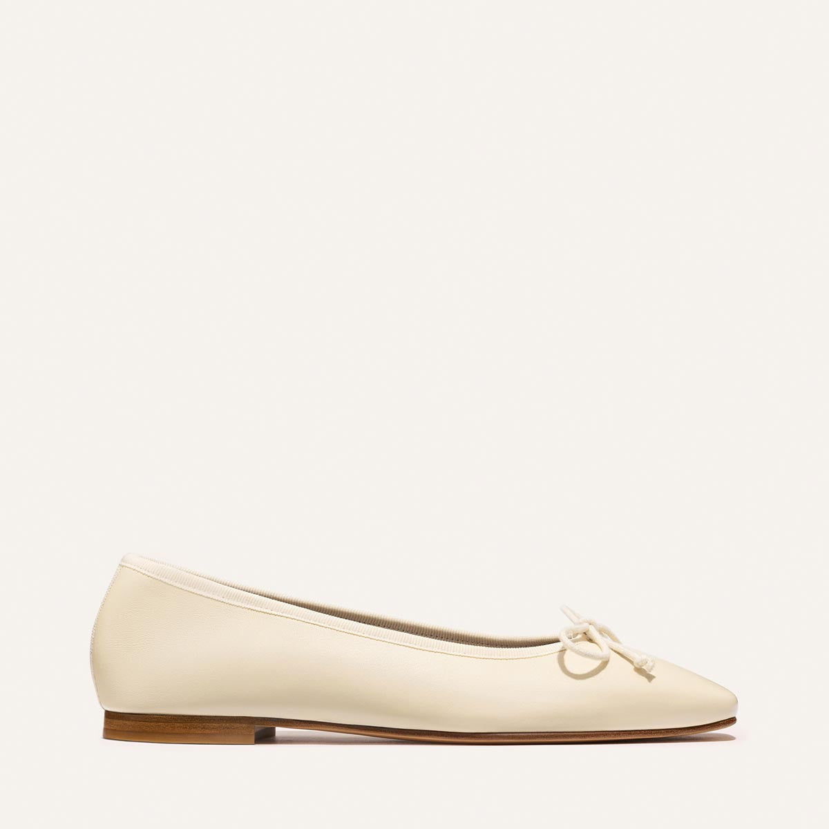 Beige flat shoe on a white background