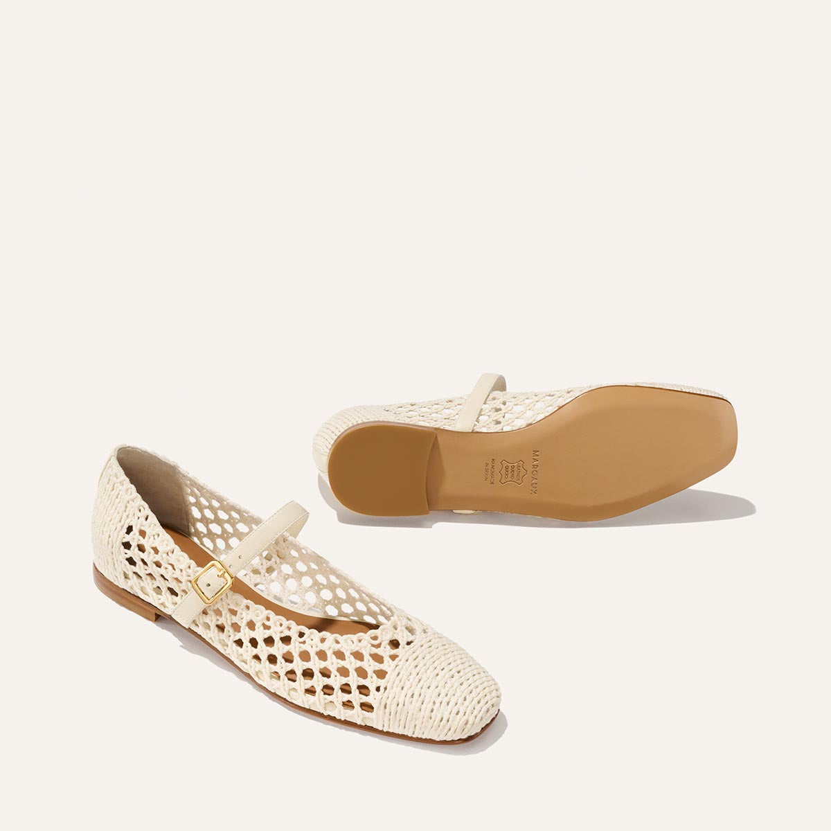 The Fonteyn Jane - Ecru Macrame by Margaux: cream-colored cotton macrame Mary Jane flats with tan soles and a small adjustable strap, shown upright and on its side to display the sole.