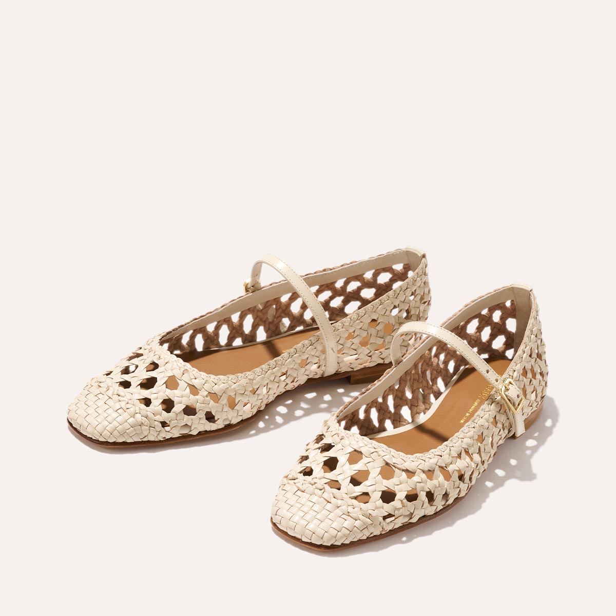 The Fonteyn Jane - Ecru Woven Leather by Margaux: beige handwoven leather flats with cutout details, closed toes, and a slim adjustable instep strap, shown on a plain light background.