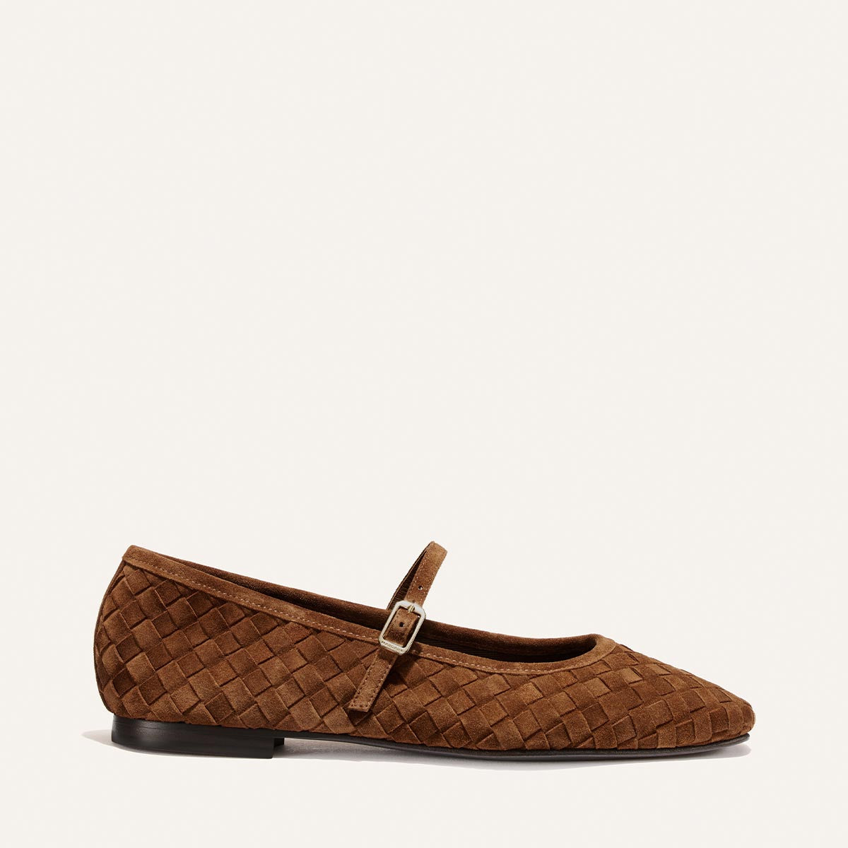 A single Margaux "The Fonteyn Jane" flat in Saddle Woven Pasado Suede is shown in profile on a plain light background, featuring a slim strap and small buckle.