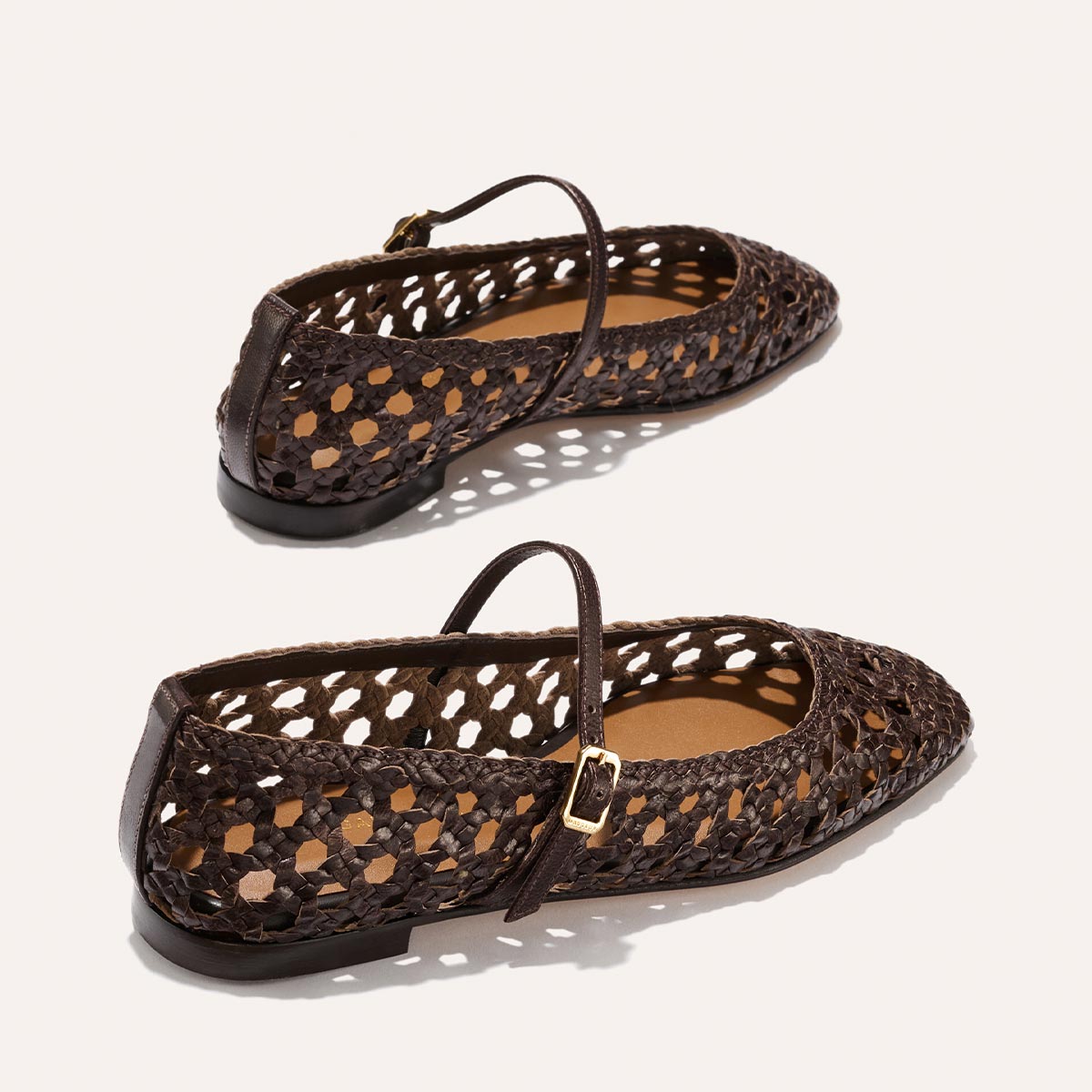 The Fonteyn Jane - Espresso Woven Leather by Margaux: dark brown handwoven Mary Jane flats with pointed toes, adjustable ankle straps, and gold buckles, shown on a light background.