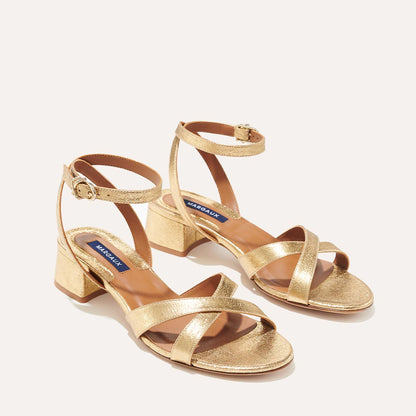 The Lena Sandal in metallic Gold Crinkle Nappa, featuring perfectly placed straps around the ankle and toes and a comfortable 1.5-inch block heel.