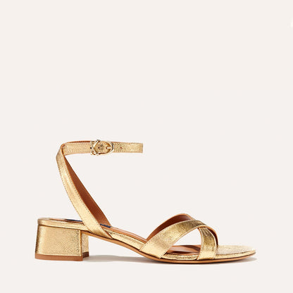 The Lena Sandal in metallic Gold Crinkle Nappa, featuring perfectly placed straps around the ankle and toes and a comfortable 1.5-inch block heel.