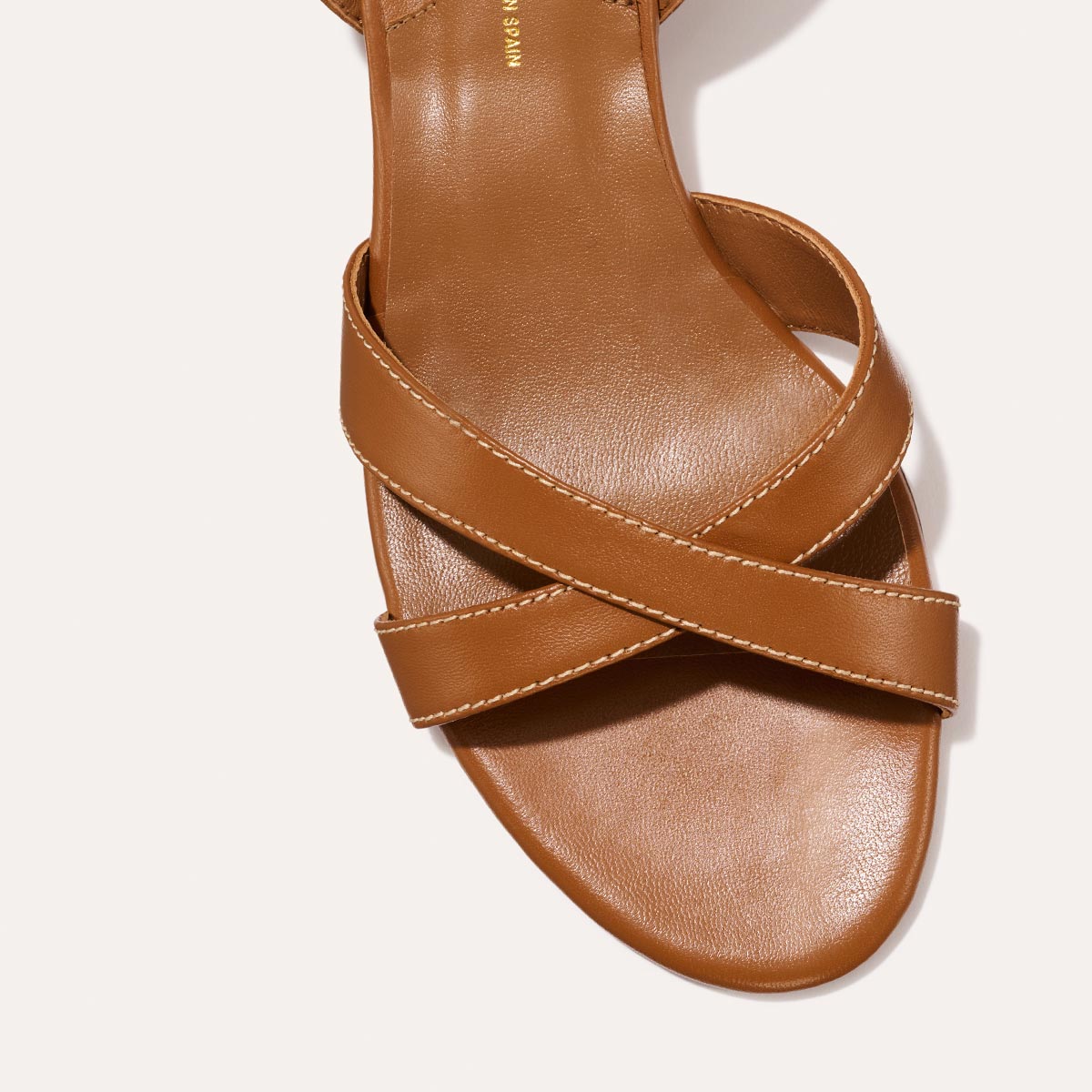 The Lena Sandal in classic Saddle Nappa, featuring perfectly placed straps around the ankle and toes and a comfortable 1.5-inch block heel.