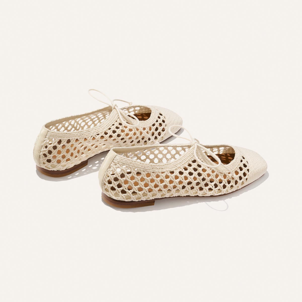The Luna - Ecru Macrame by Margaux: cream ballet flats featuring cotton macrame woven open mesh sides and lace-up fronts, ideal for a breezy summer look, shown on a white background.
