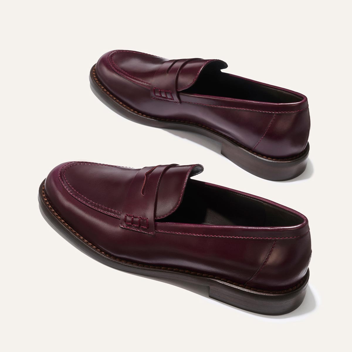 The Marlowe Loafer - Burgundy Calf by margaux-development: classic penny slot burgundy leather loafers with brown soles and visible stitching, shown on a neutral background.
