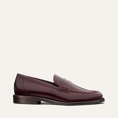 The Marlowe Loafer - Burgundy Calf by margaux-development is shown in a side profile, displaying burgundy leather, a low heel, and stitching detail against a plain light background.