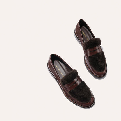 The Marlowe Loafer by Margaux in Mahogany Calf and Shearling, featuring brown leather with dark fur accents, displayed against a light neutral background.
