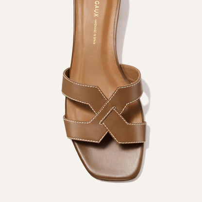 The MX 35 - Mocha Calf by Margaux is a brown leather sandal with white stitching, wide crisscross straps, a square toe, and a comfortable block heel for easy walking.