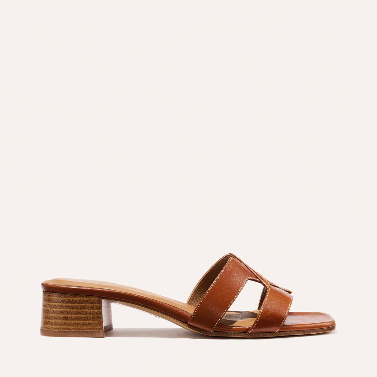 The MX 35 - Saddle Calf by Margaux-development is a brown leather sandal with an open toe, two wide straps, and a comfortable low block heel, shown in side profile against a plain light background.
