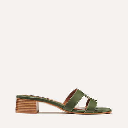 The margaux-development MX 35 - Olive Calf sandal features olive green calf leather, open toe, wide cut-out straps, and a low block heel—an elevated take on a classic design—shown against a simple light background.