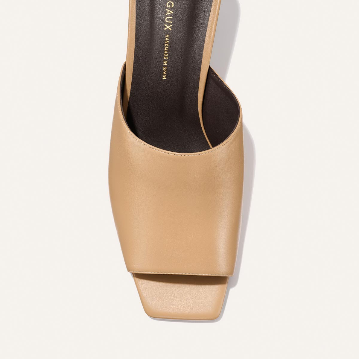 Beige high-heeled shoe with 'MARGAUX' branding on a light background